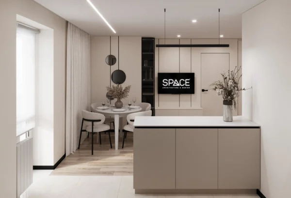 The kitchen island separates the cooking zone from the dining area and TV wall
