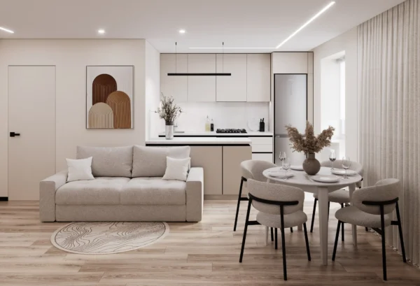 Apartment interior design in Khmelnytskyi: open-plan studio with a light sofa, round dining table and kitchen island by the window
