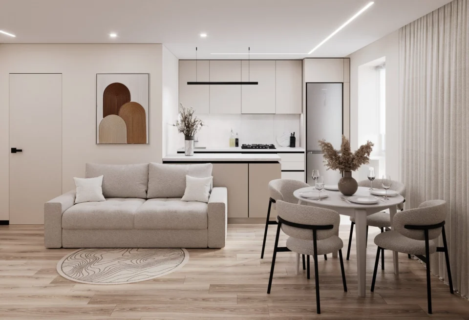 Apartment interior design in Khmelnytskyi: open-plan studio with a light sofa, round dining table and kitchen island by the window