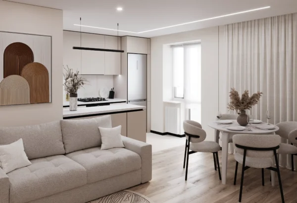 Living area with a sofa, warm-toned artwork and a dining area against the kitchen
