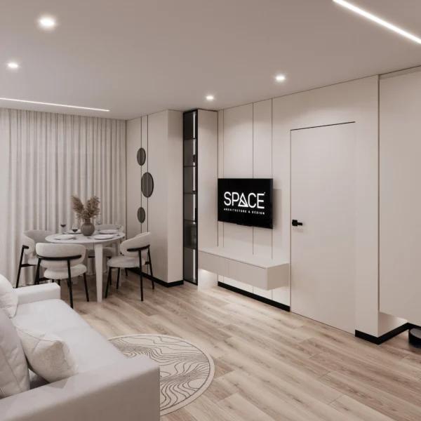 Open-plan studio with a sofa, dining area, TV wall and wood-look flooring