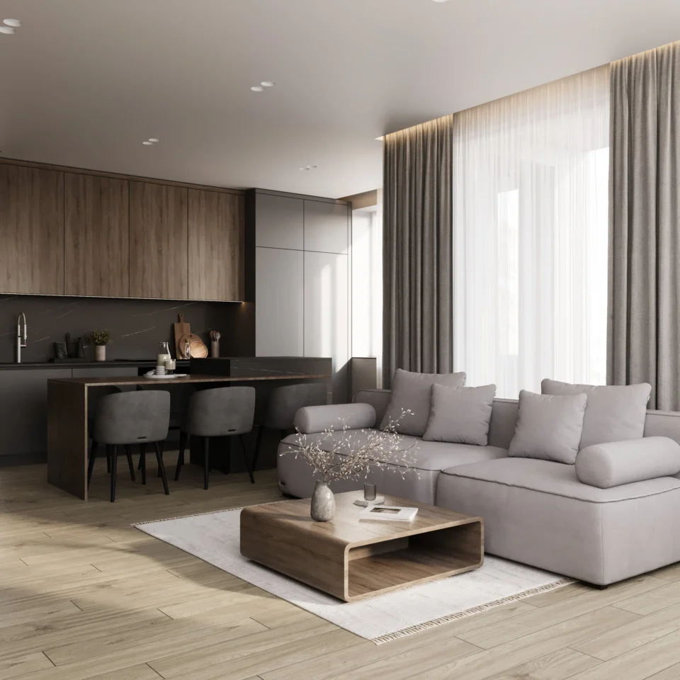 Salon z aneksem: szara sofa modułowa, drewniany stolik kawowy i kuchnia z barem