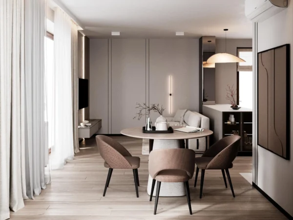 Dining area with a round table and upholstered chairs, looking towards the kitchen and lounge