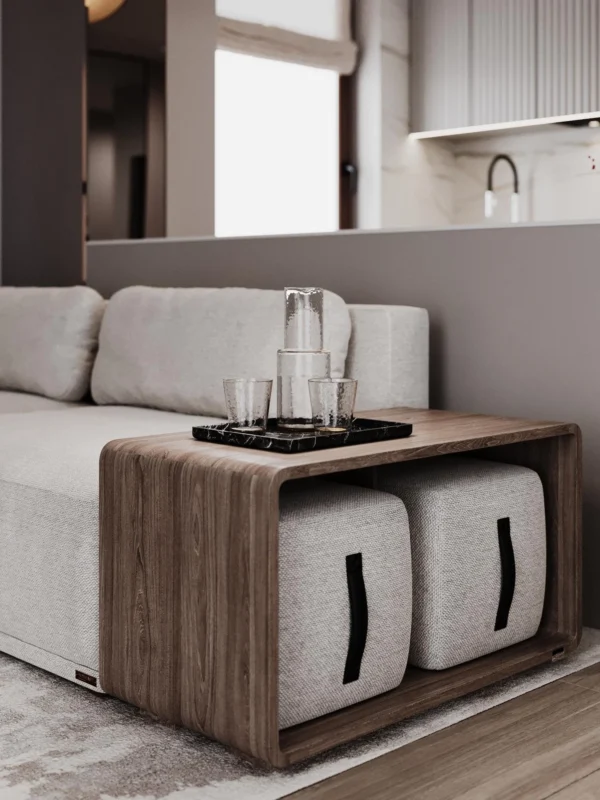 Living room detail: wooden side table with two poufs next to the sofa