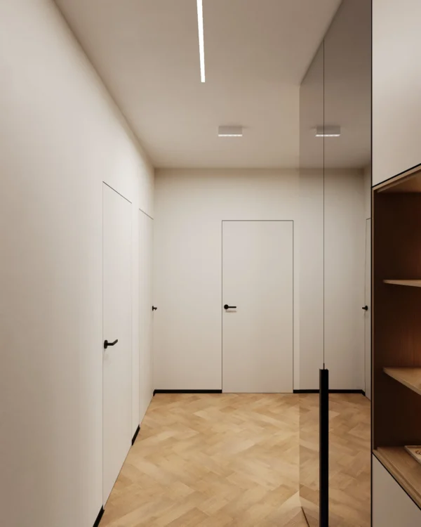 Corridor with white flush-mounted doors and black skirting