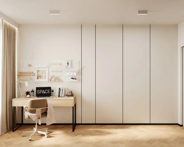Study desk with a pegboard organiser and white floor-to-ceiling wardrobes in the kids' room