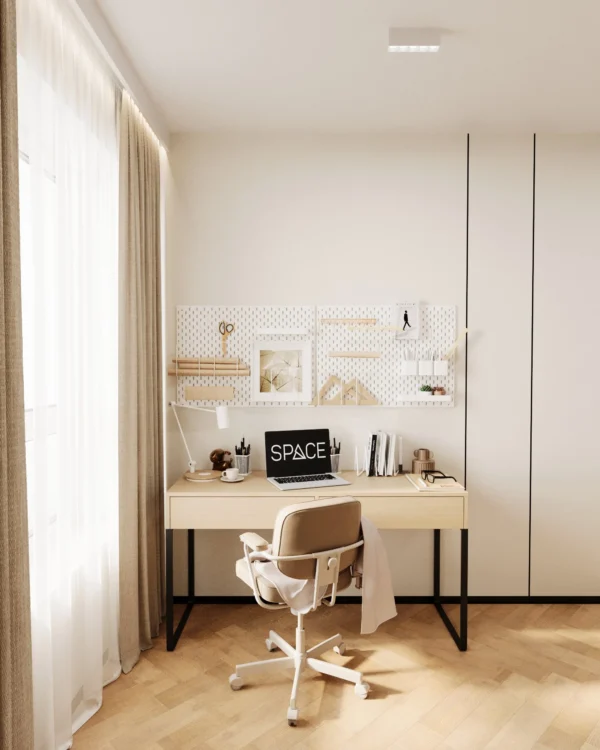 Desk by the window with an office chair and a pegboard