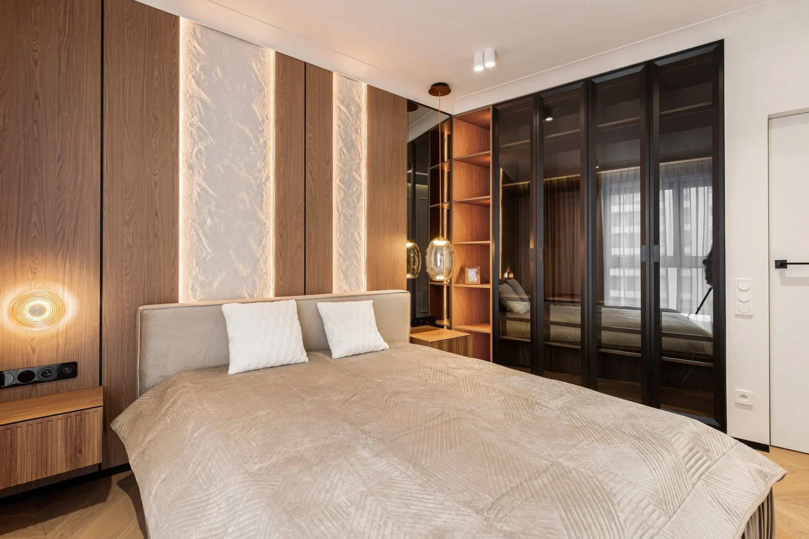 Bedroom with a black-framed tinted-glass wardrobe and open shelving