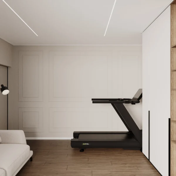 Home gym in the guest room: treadmill by a moulded wall