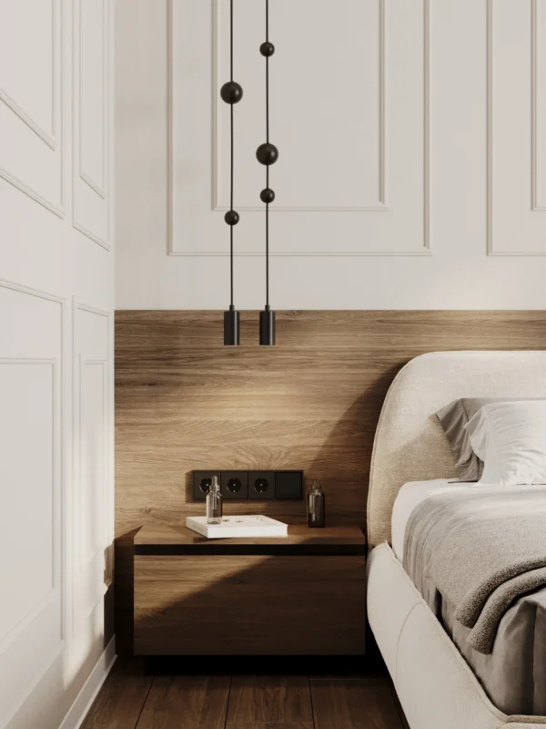 Bedroom detail: pendant lights over a bedside table against a wood panel