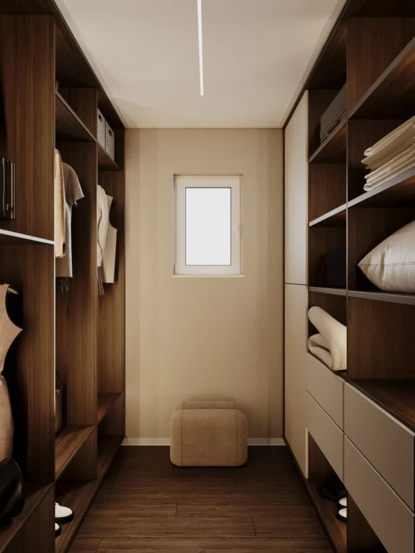 Walk-in wardrobe with a window, a pouf and closed drawers below the shelves